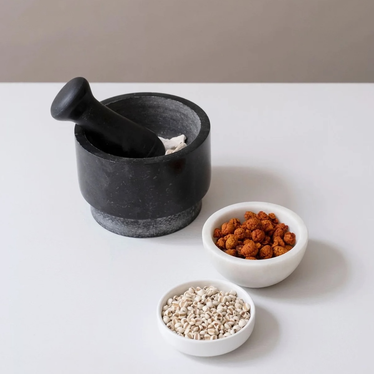 Mortar and pestle with dried herbs — botanical ingredients used in custom Daodi formulas